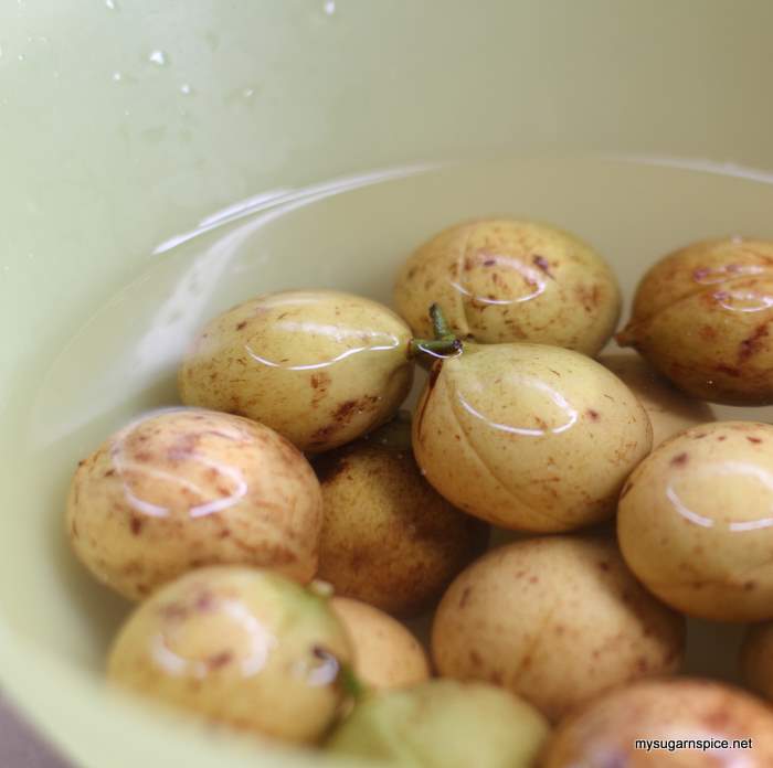 Soaking washed nutmeg in water mixed with a cap of garbage enzyme